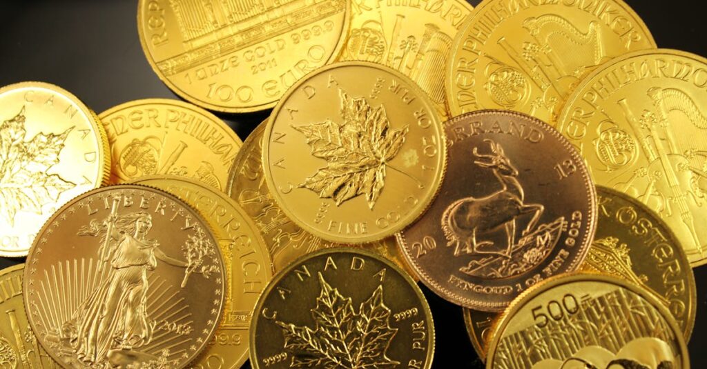 A detailed close-up of diverse gold bullion coins from different countries.